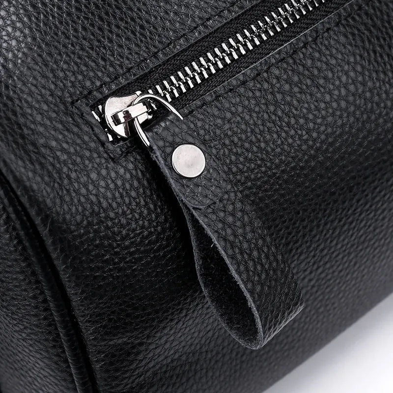 Black genuine leather women's crossbody bag showing front view and adjustable strap