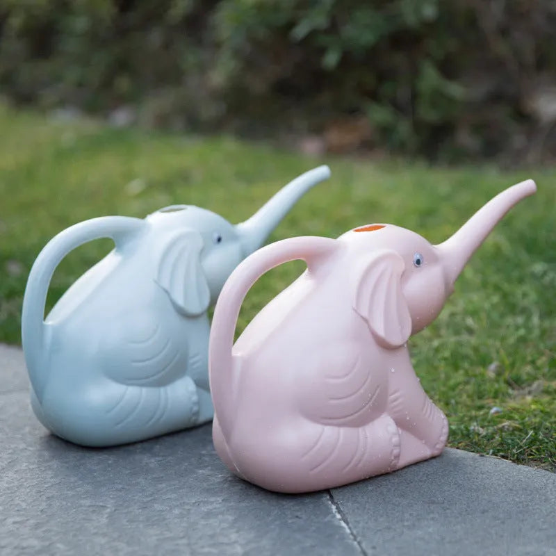 Pink children's watering can shaped like a sitting elephant with a long spout and baby-bottle handle.