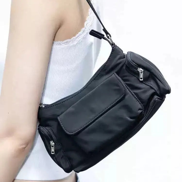 Black PU leather women's shoulder bag with side line detail and double interior pockets.
