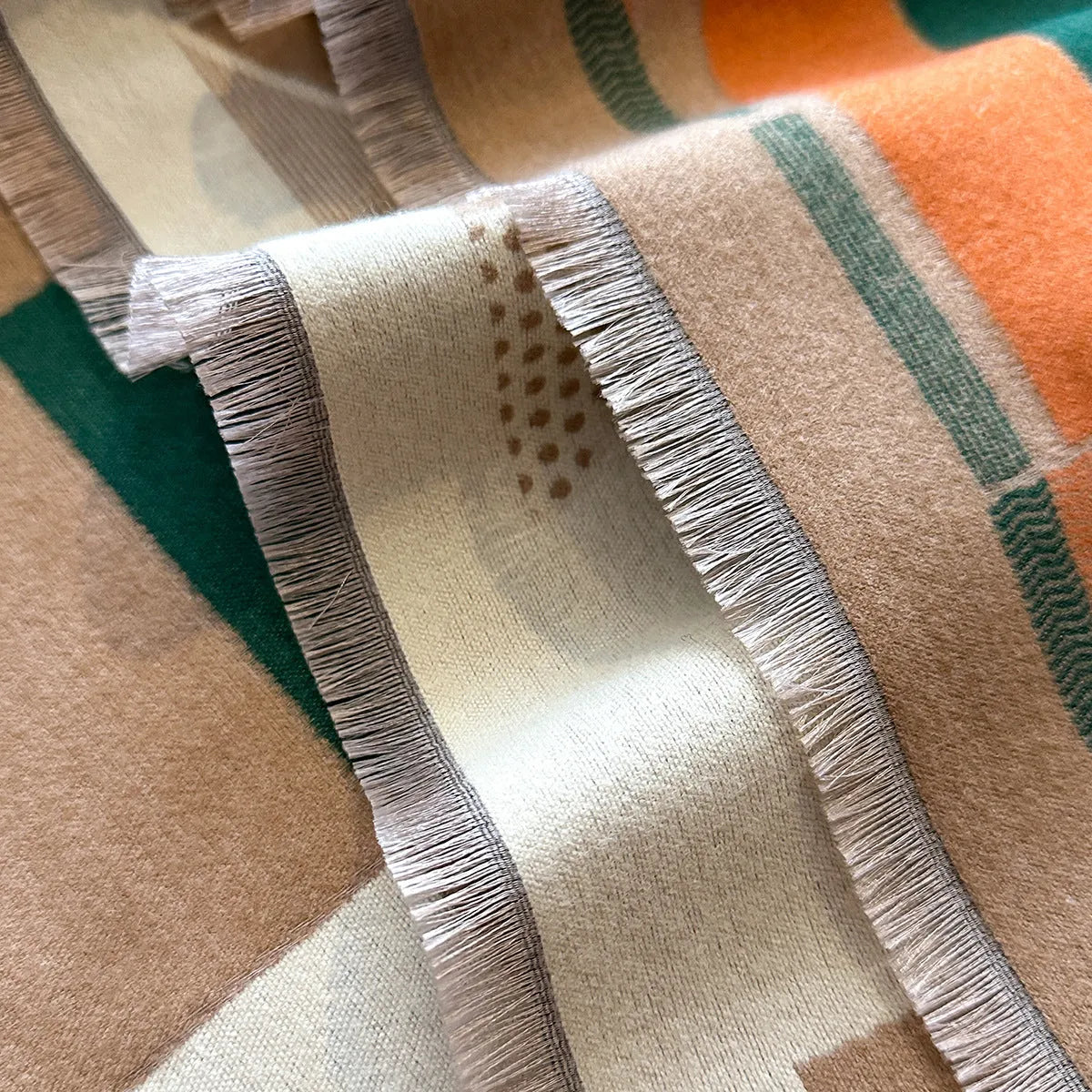 Long beige imitation cashmere style polyester scarf draped to show its 185 cm length and texture.
