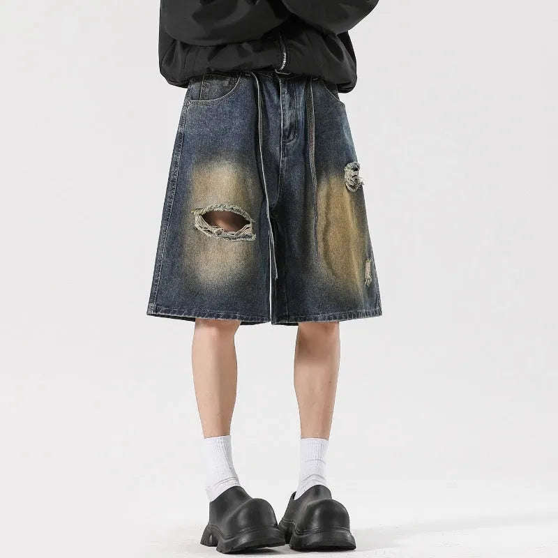 Men's distressed loose fit jeans in retro blue cotton denim with ripped detailing