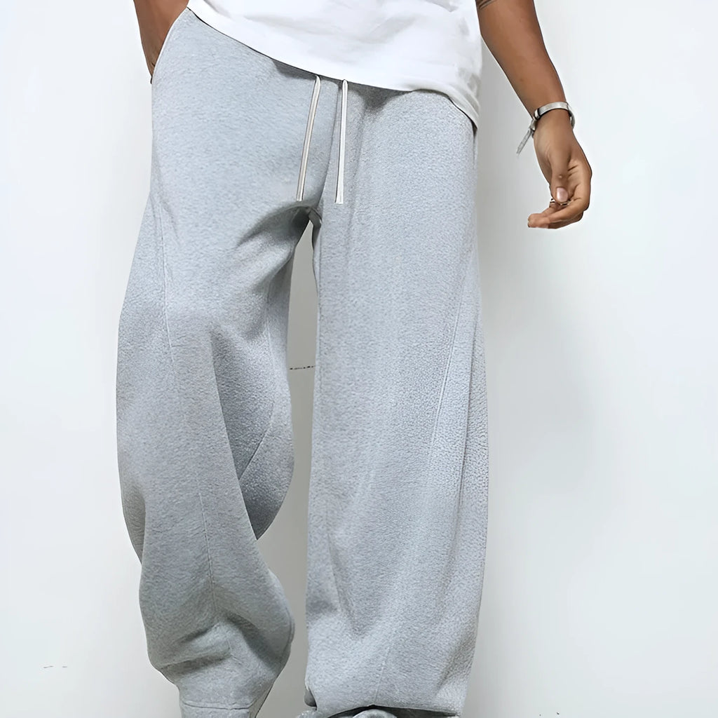Men's straight leg casual trousers with a drawstring waist in black, dark grey, or light grey.