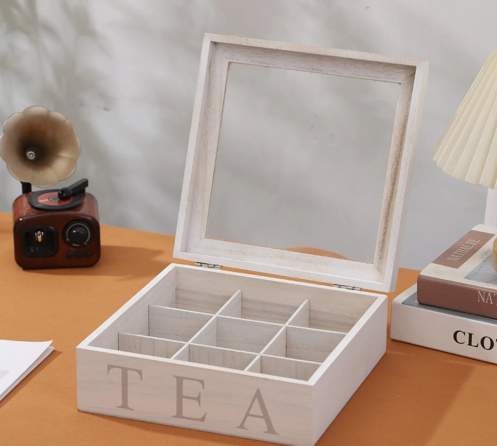 White wooden multi-grid coffee storage box with transparent cover on a desk