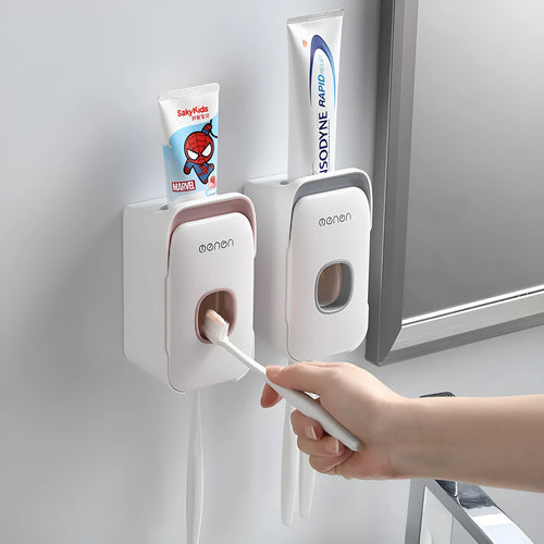 Automatic wall-mounted toothpaste dispenser in blue colour on a bathroom wall.