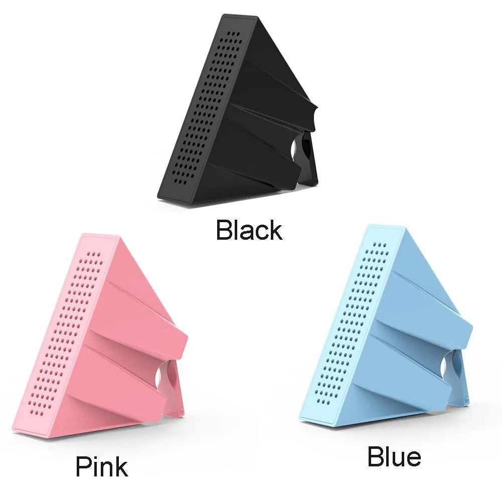 Mini black mobile phone amplifier bracket holding iPhone on desktop surface
