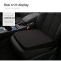 Black car seat cushion for height adjustment measuring approximately 42x39x6cm