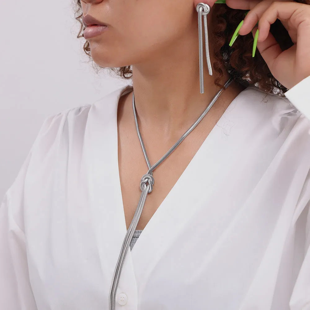 Gold electroplated titanium steel necklace with knotted tassel pendant and matching earrings set