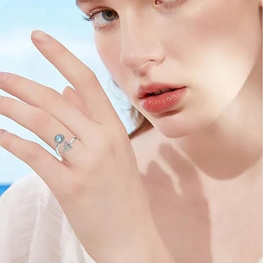 Rotating moonstone ring bracelet in white gold colour with adjustable opening and geometric circle triangle design
