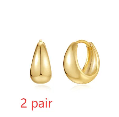 Brass geometric earclip earrings with gold electroplated finish and round design elements