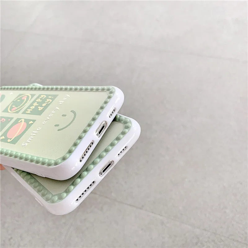 Green iPhone case with geometric pattern and smiley face polka dot design on a soft TPU back cover.