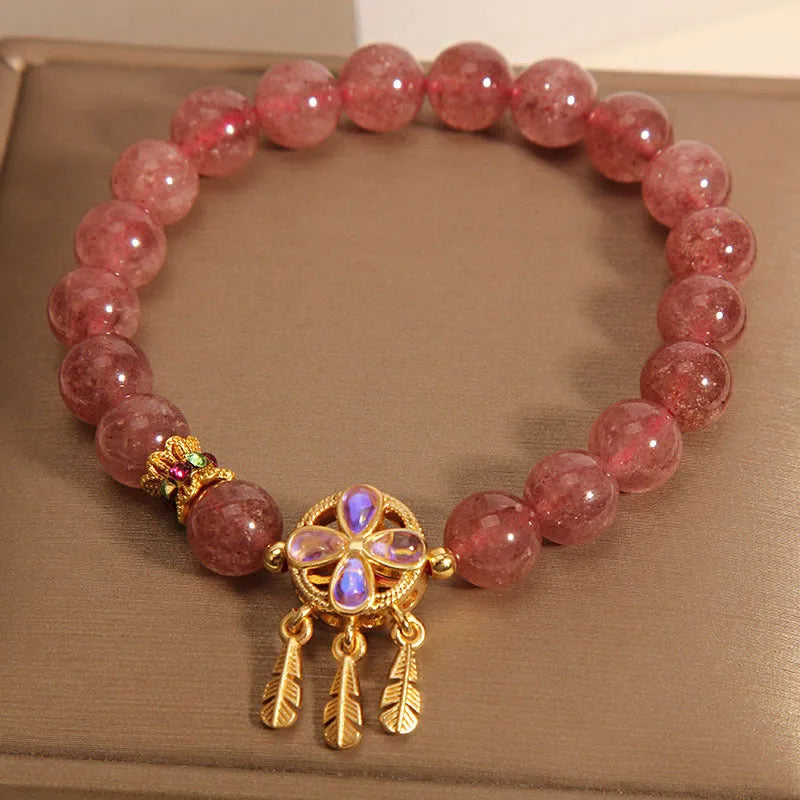 Women's adjustable strawberry quartz bracelet with four leaf dream catcher ball pendant and crystal beads