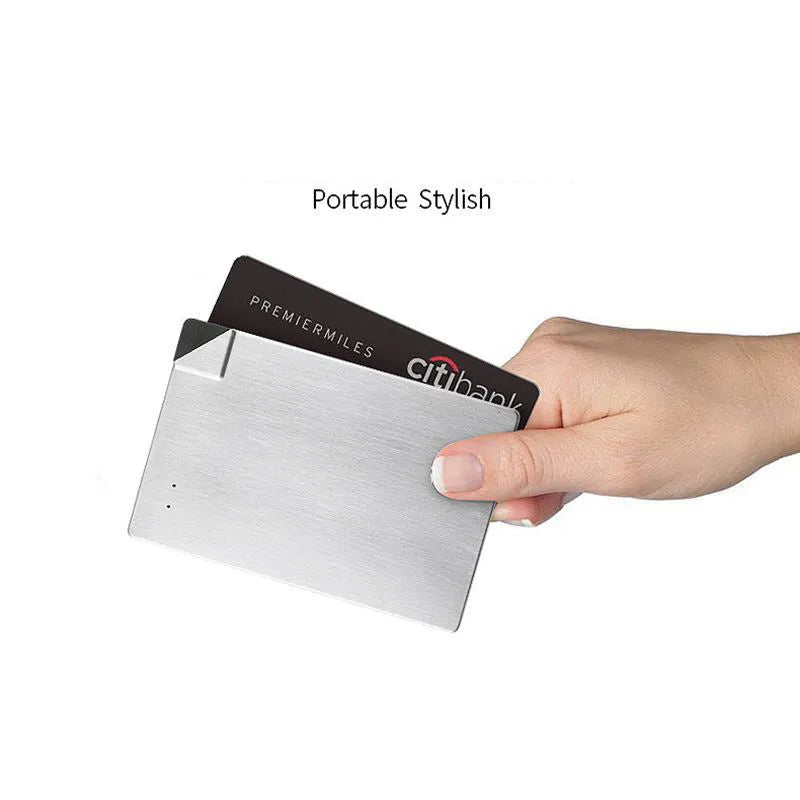 Ultra-slim silver graphene battery power bank 4000mAh on surface with cables