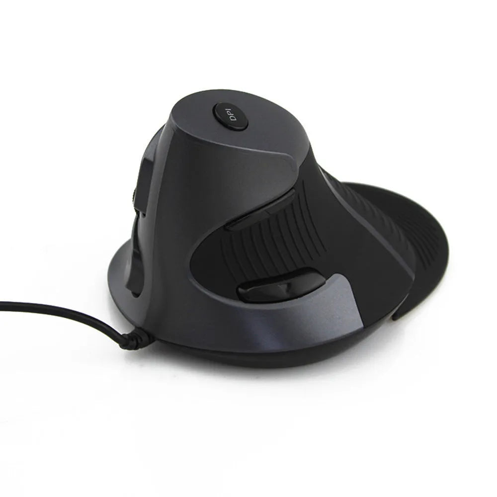 Black and white ergonomic vertical mouse with wired USB cable on a desk.