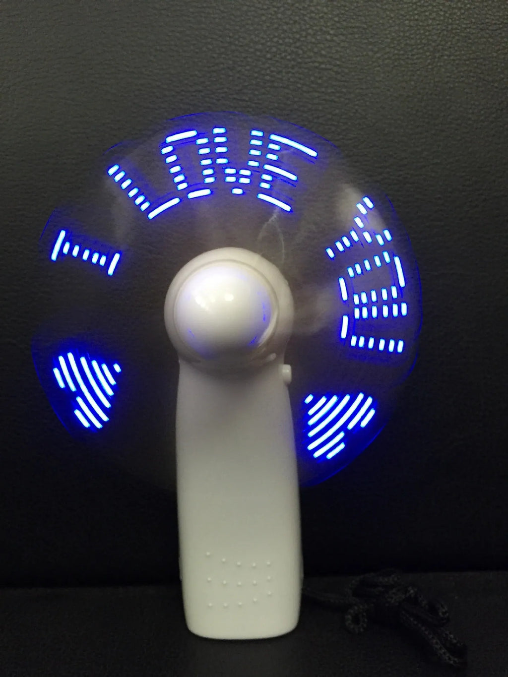 White handheld mini fan with LED love pattern display showing blue and red colours