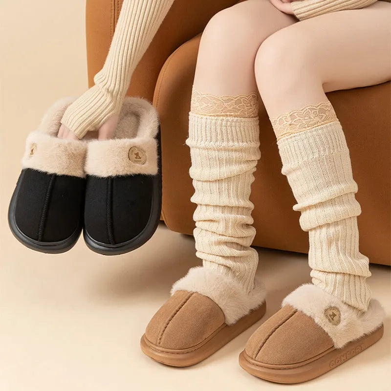 Pair of thick-soled plush fleece slippers for men and women with a textured upper and PVC sole.