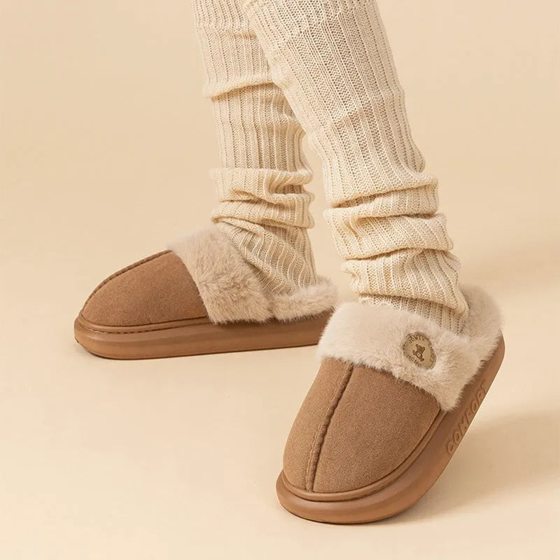 Pair of thick-soled plush fleece slippers for men and women with a textured upper and PVC sole.