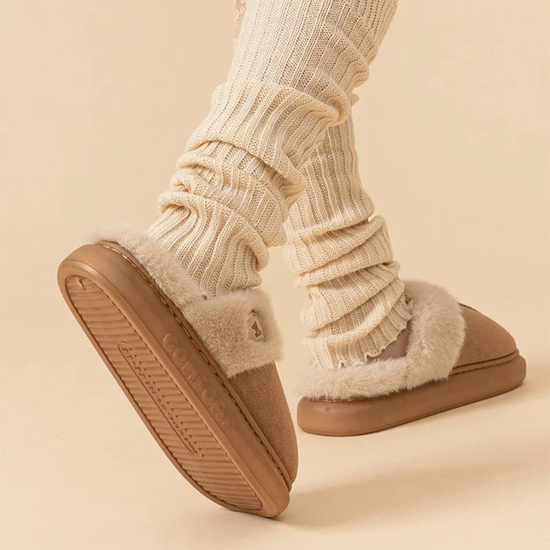Pair of thick-soled plush fleece slippers for men and women with a textured upper and PVC sole.