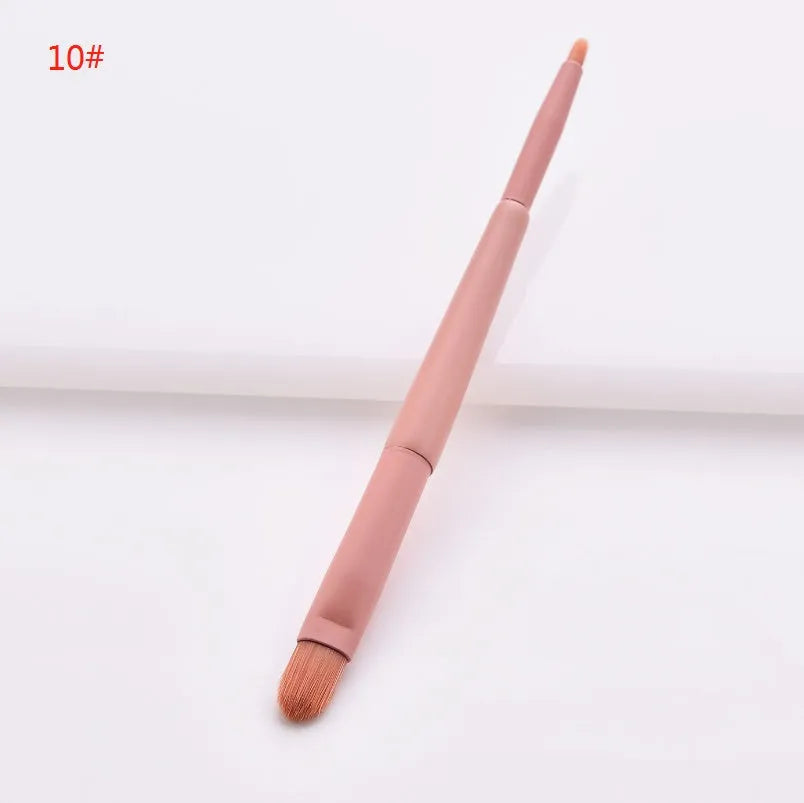 10-piece cosmetic brush set with pink wooden handles and nylon bristles arranged with makeup