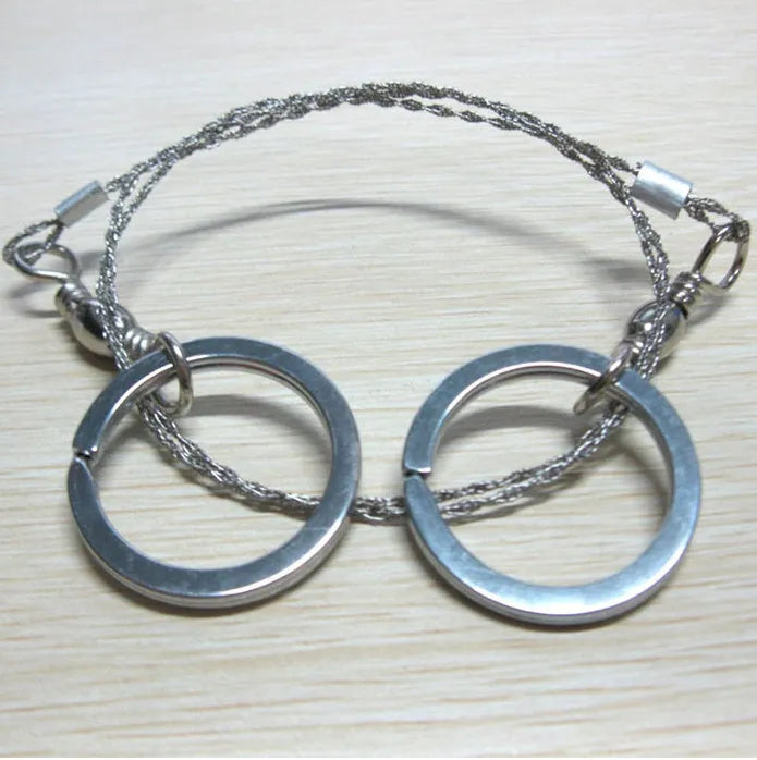Stainless steel survival wire saw with thumb rings, showing extended length of 70cm.