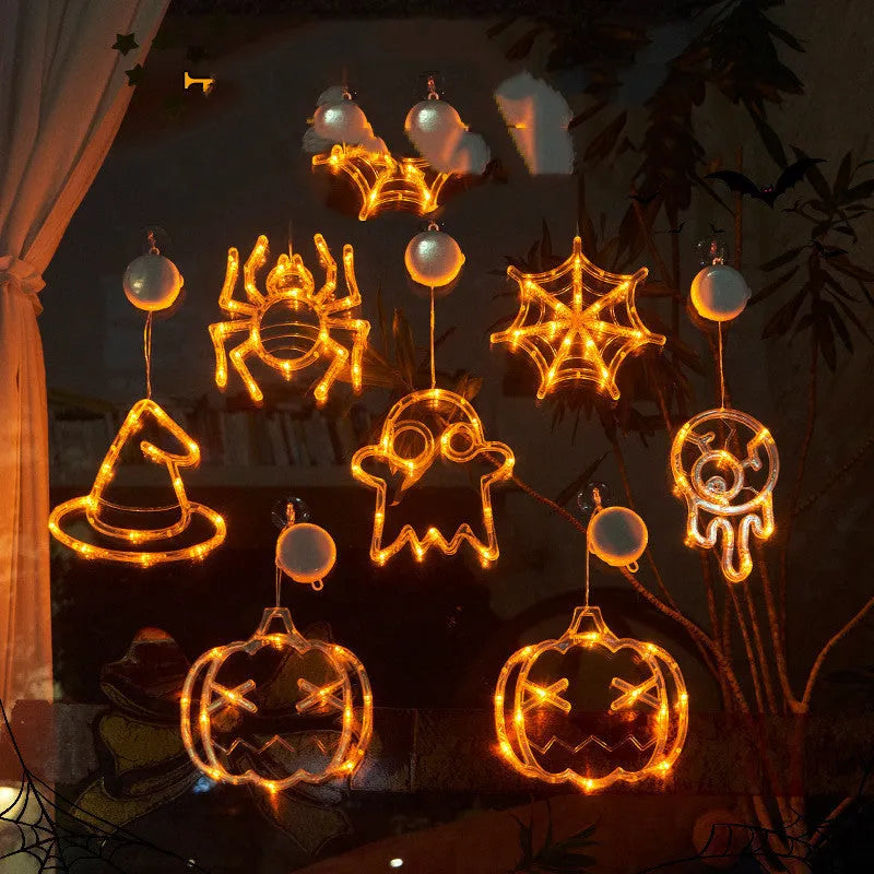 Seven Halloween LED window lights with spider, pumpkin, and ghost designs featuring suction cups for mounting