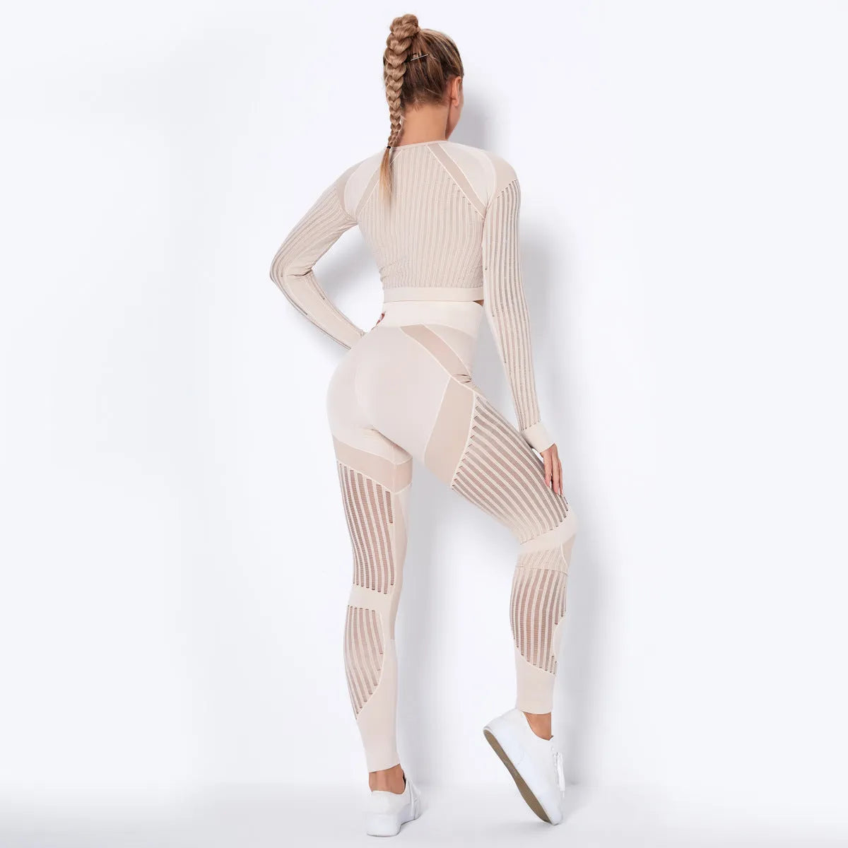 Woman wearing a seamless long-sleeved striped yoga suit in a stretch pose.