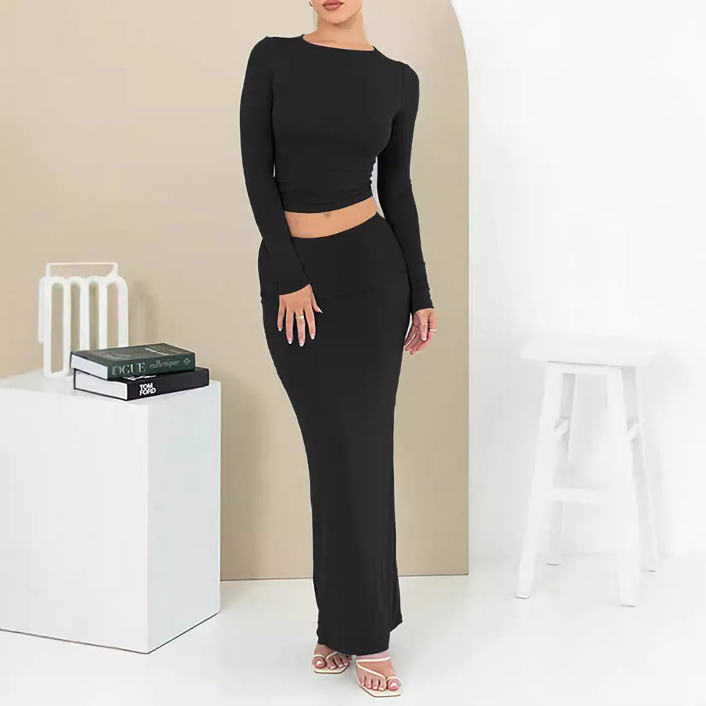 Women's black two-piece suit set with three-quarter sleeve top and long skirt on a mannequin.