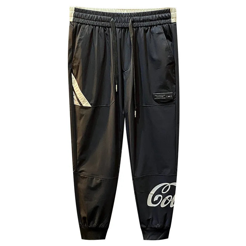 Man modelling black ultra-thin ice silk ankle banded casual cropped trousers.
