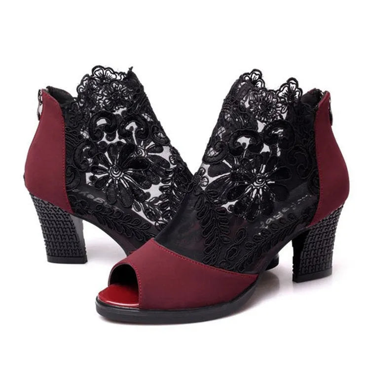 Black women's gladiator sandals with lace upper, square heel, zip closure, and peep toe.