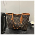 Structured PU shoulder bag in neutral colour with sewing thread detail and a long handle.