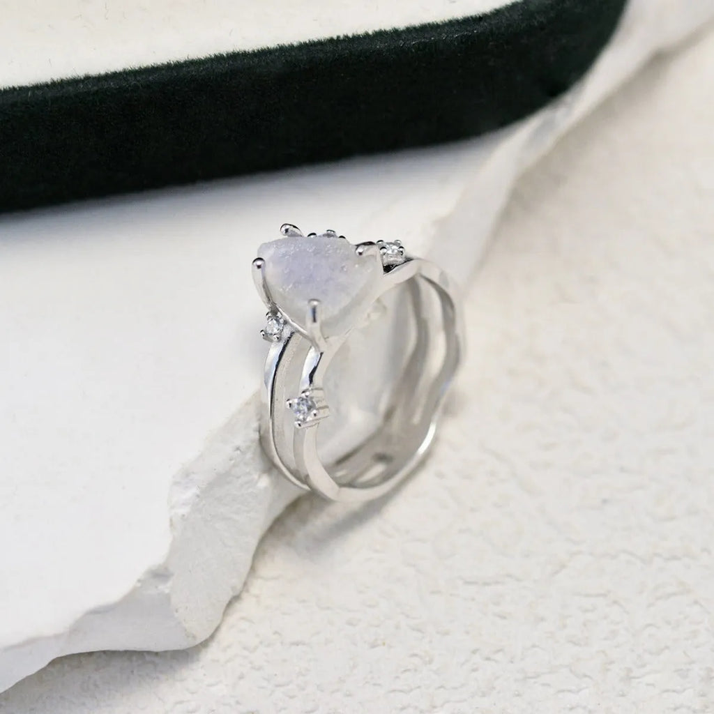S925 silver geometric ring featuring an irregular triangle design with a moonstone, shown in rose gold, white gold, and yellow gold finishes.