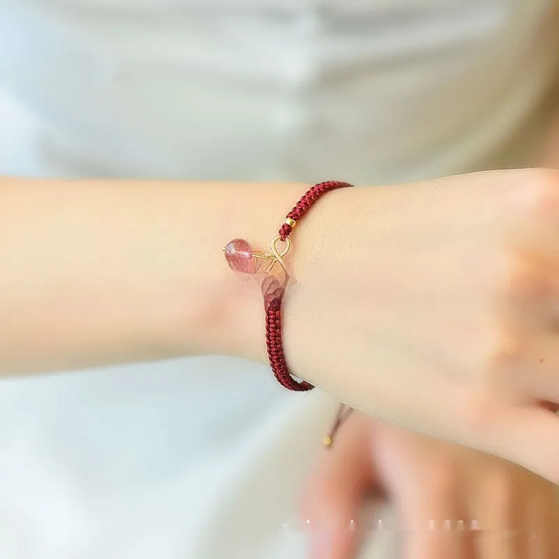 Women's natural strawberry quartz crystal cherry bracelet with adjustable cord on wrist