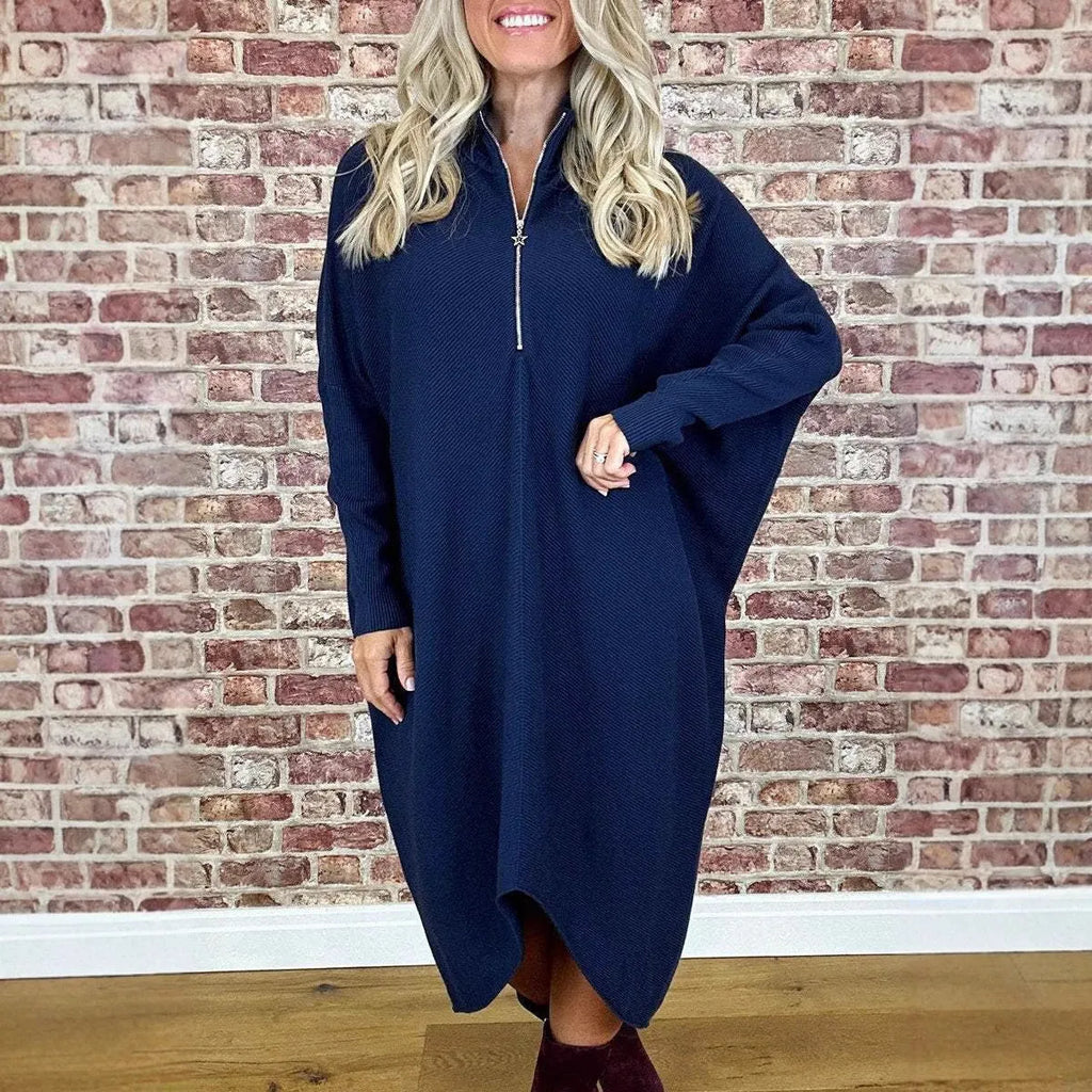 A women's solid colour loose knitted dress with raglan sleeves and a front zipper.