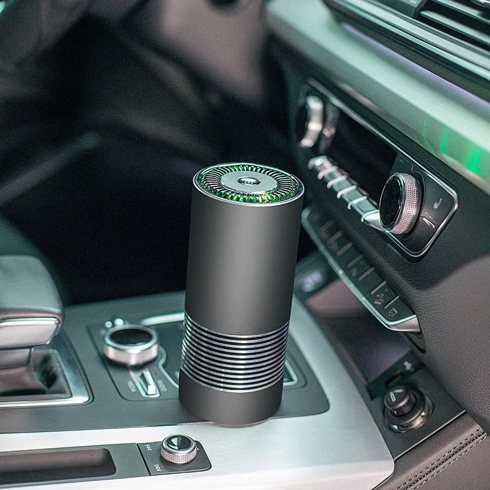 Wireless car air purifier in black, metallic grey, or silver colours, showing compact size for dashboard use.