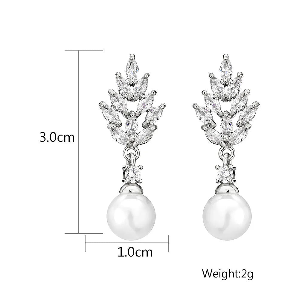 A pair of geometric stud earrings with a flower design and micro inlaid zircon, shown in gold plating.