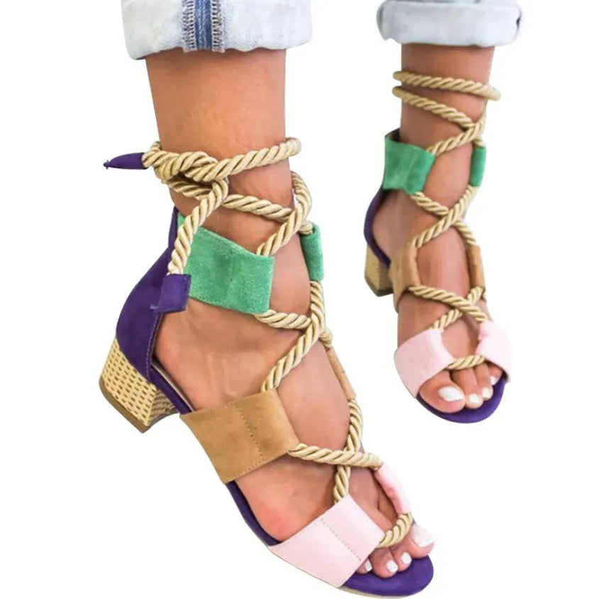Women's beige suede sandals with thick heel and front strap.