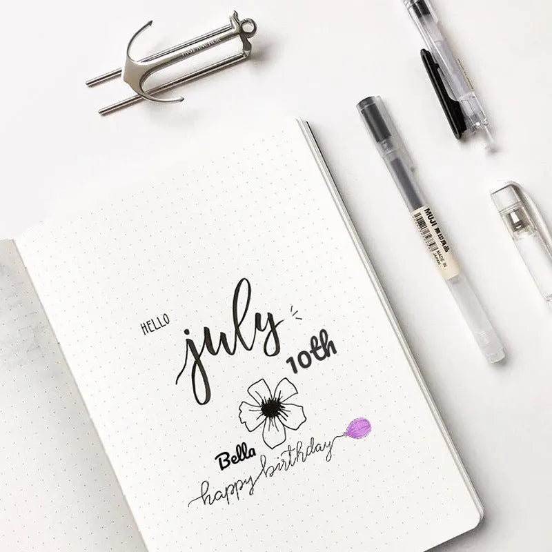 A5 dotted notebook with imitation leather cover in blue or pink colour options showing dot matrix interior pages