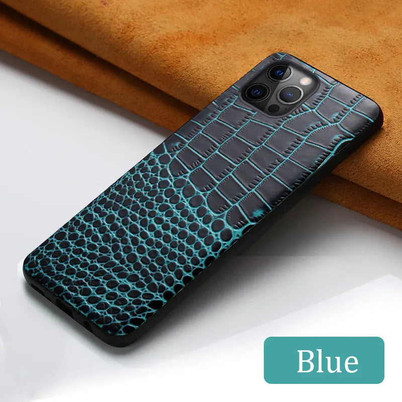 Handmade black leather iPhone case with a crocodile pattern texture on a table.