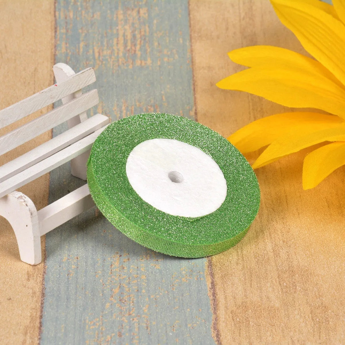 A roll of colourful green onion pattern polyester ribbon with metallic wire highlights, shown at 3-points width.