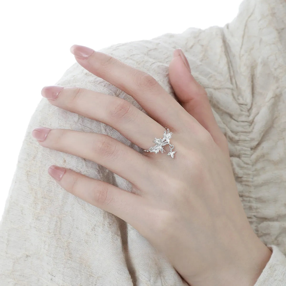 Adjustable silver ring with a detailed butterfly design in a choice of white gold or gold colour finish.
