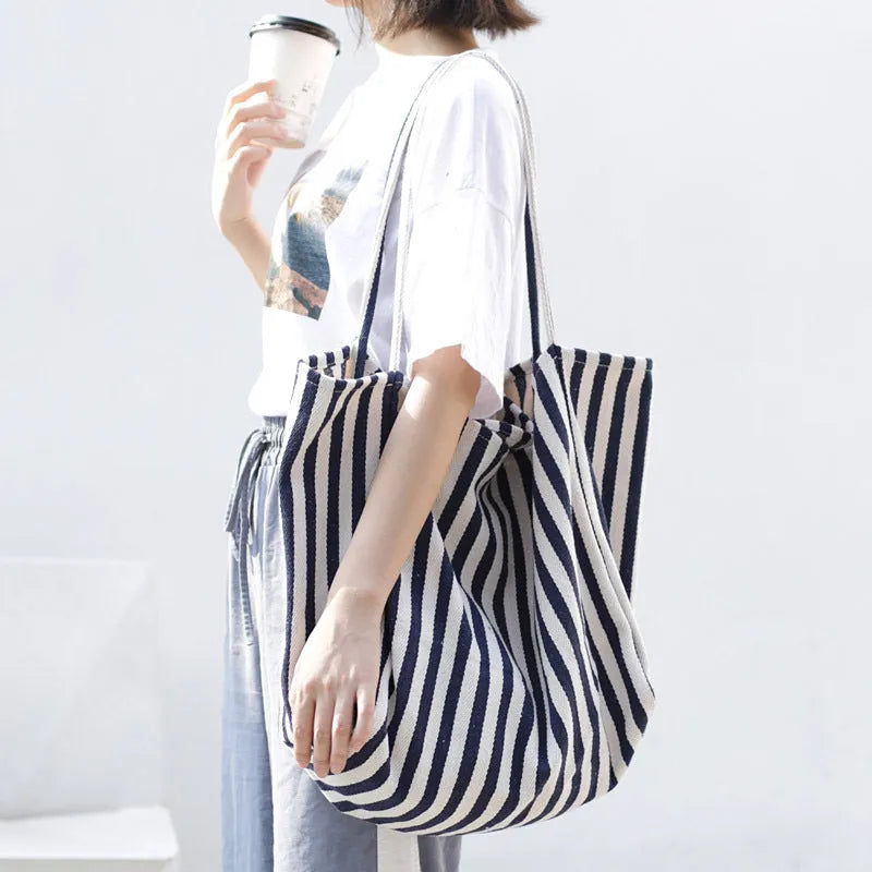 Striped canvas shoulder bag in black, blue, or red with 39cm bottom length, 35cm height, 21cm thickness, and certificate bag.