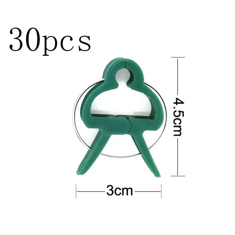 Green plastic and zinc plant fixing clips for supporting tomatoes, cucumbers, and climbing vines.