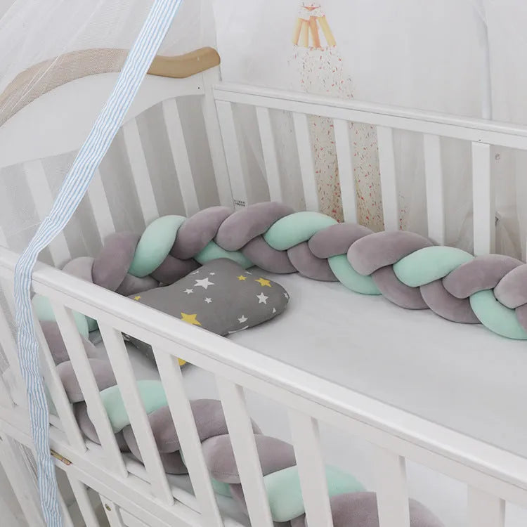 Braided knot style baby cot bumper in spandex crystal velvet fabric, shown in a light grey colour.