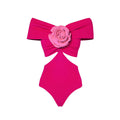 Women's floral patterned hollow out one-piece swimsuit with optional matching skirt on hanger.