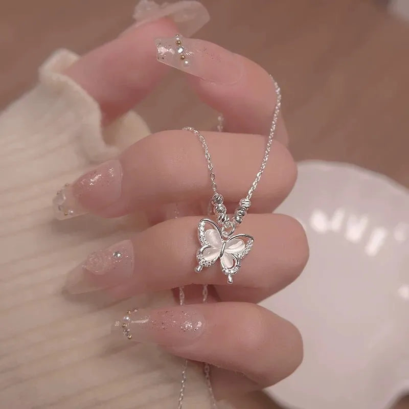 Silver opal butterfly pendant necklace with cross chain, adjustable from 41cm to 50cm.