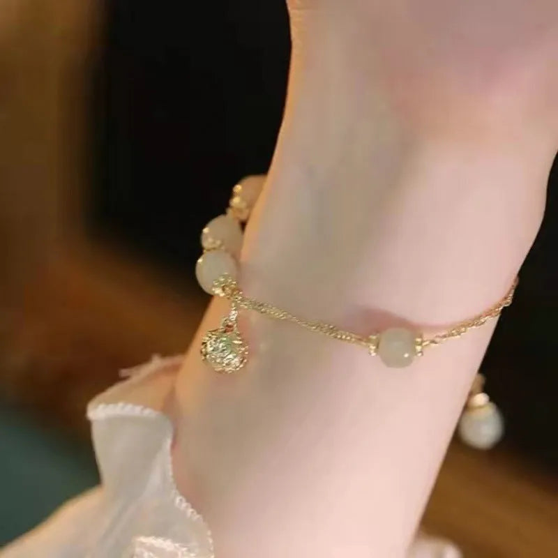 Chinese style glass bead bracelet with bamboo leaf design and manual craftsmanship details.