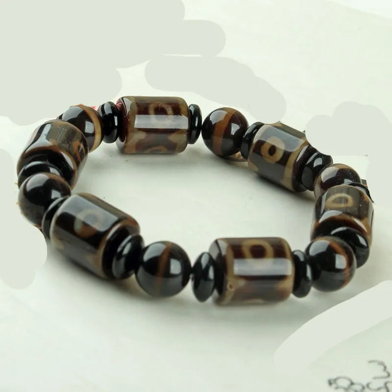 Distressed agate Tibet beads bracelet with three eye dzi design and polished stone beads