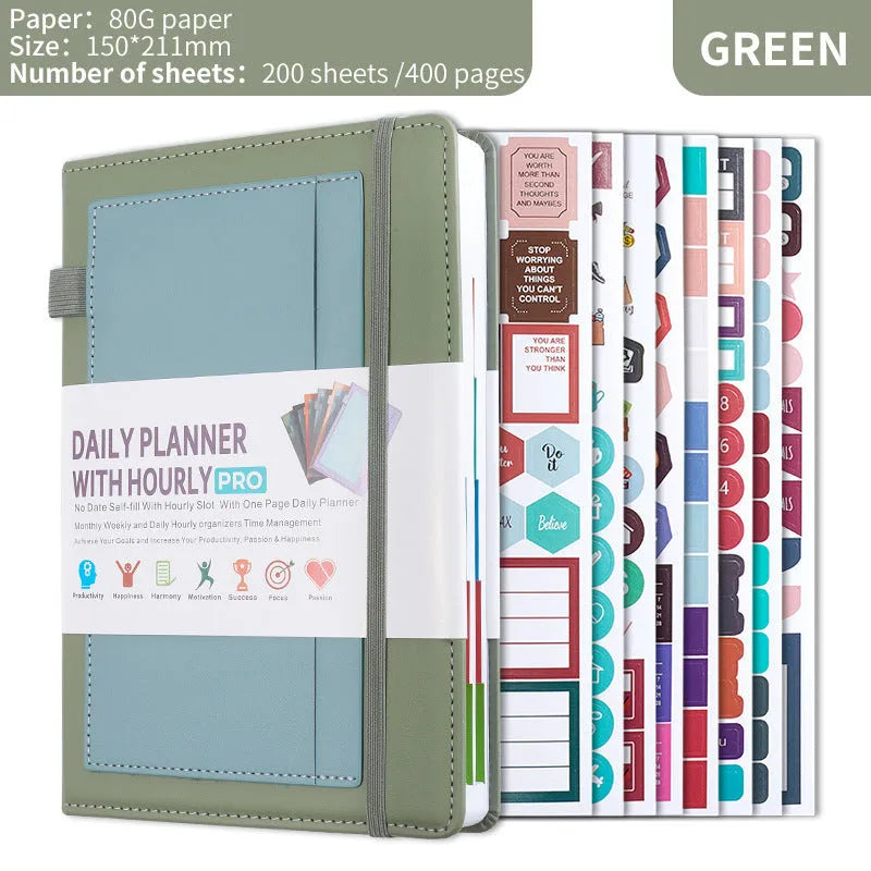 Undated A5 notebook with strap closure in purple PU cover, lying open on flat surface