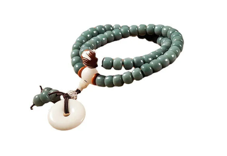 White jade bodhi seed bracelet with a double ring lotus safety buckle.