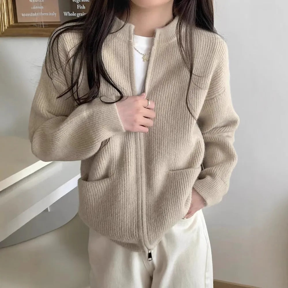 Beige soft viscose long sleeve sweater coat cardigan on a hanger.