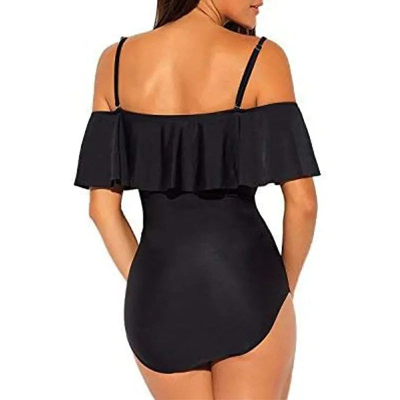 Black one-piece swimsuit with cut-out design and ruffled straps laid flat.